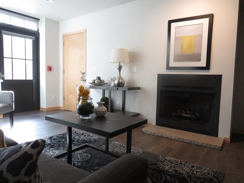 a living room with a fireplace and a couch and a coffee table